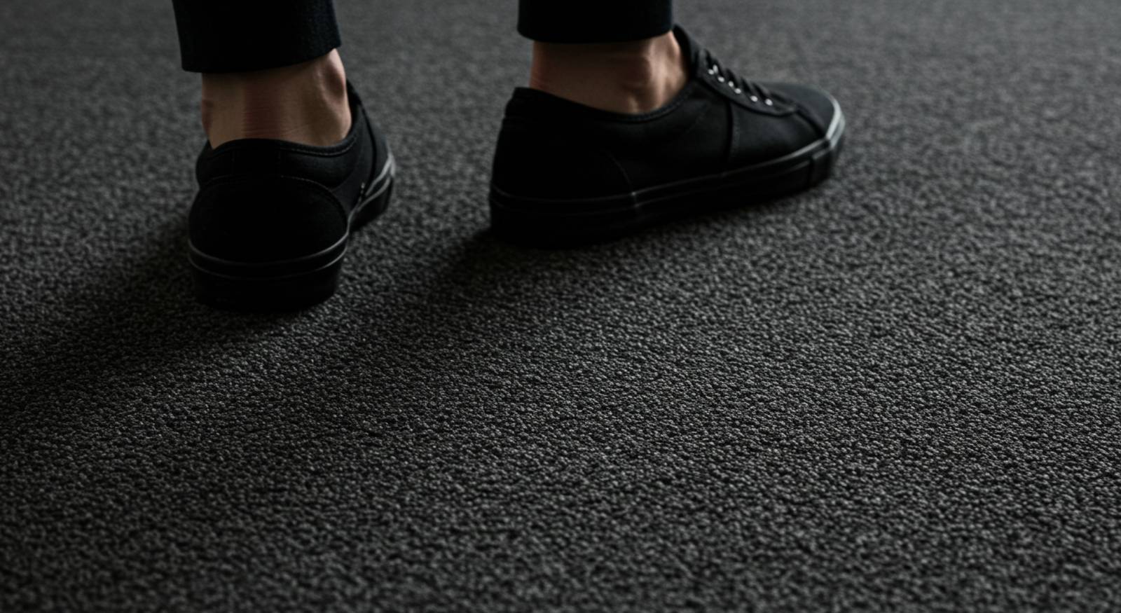 A person walking on carpet flooring.