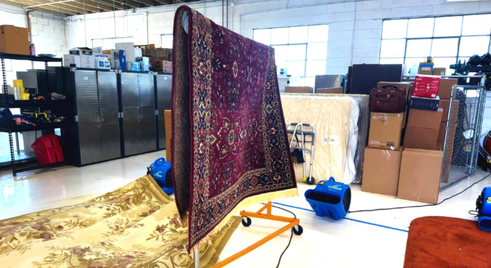 A carpet being dried with an air mover.
