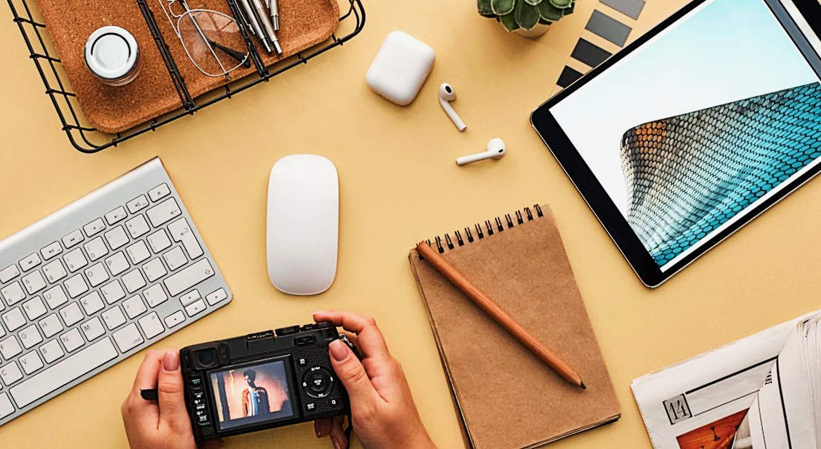 A person with his electronic devices in a table.