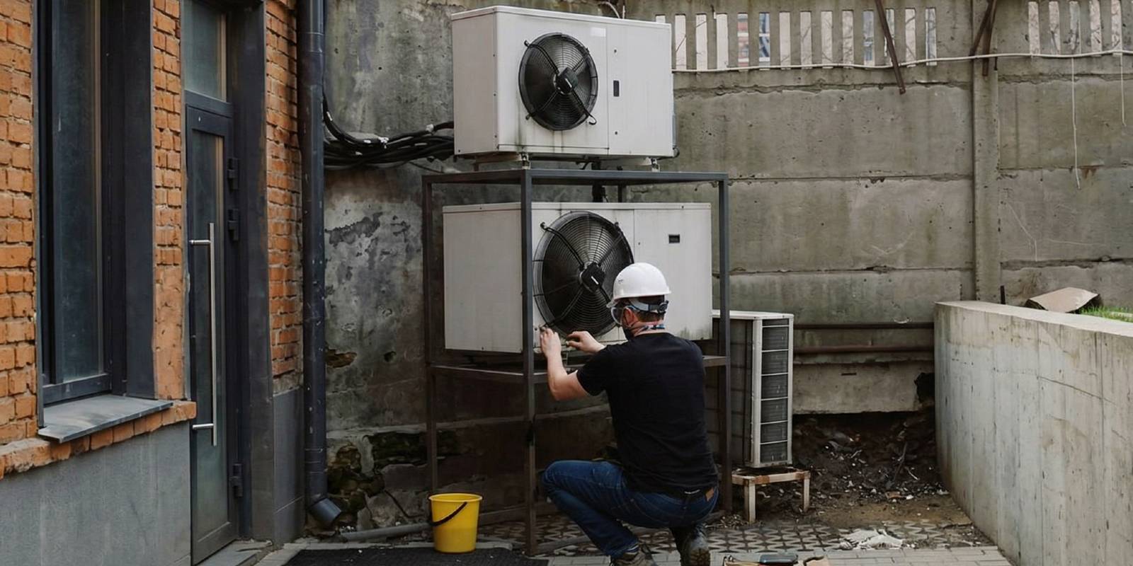 A technician cleaning an HVAC system.