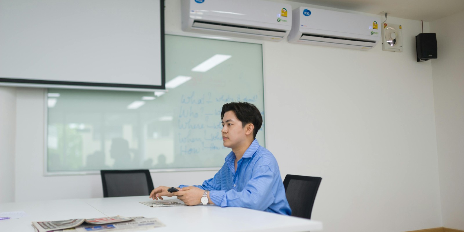 A man working at a commercial building with the Air Conditioning on.