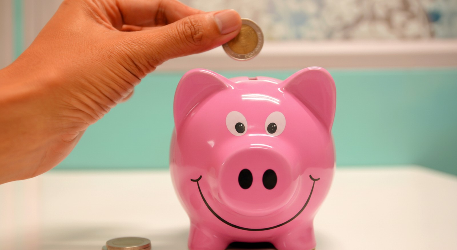 A person saving money in their piggybank