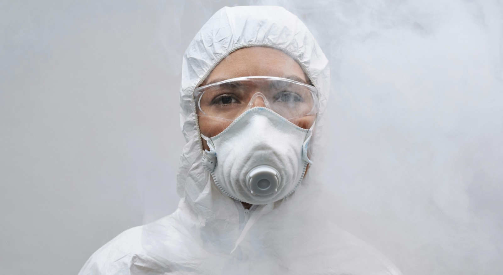 A woman technician wearing a PPE suit