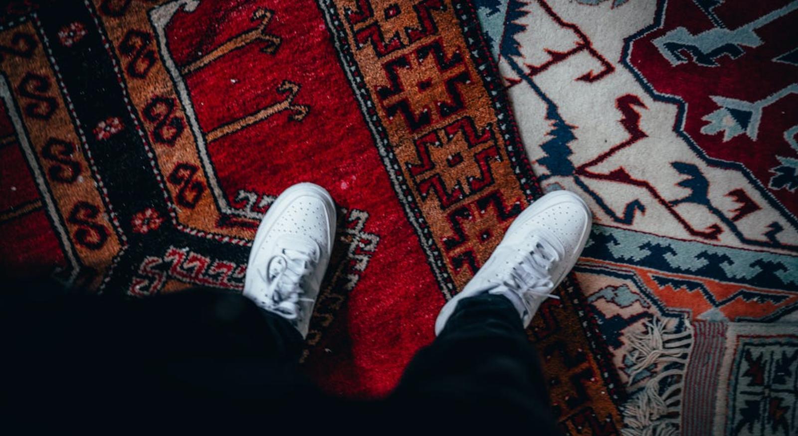 A person standing on an oriental rug.