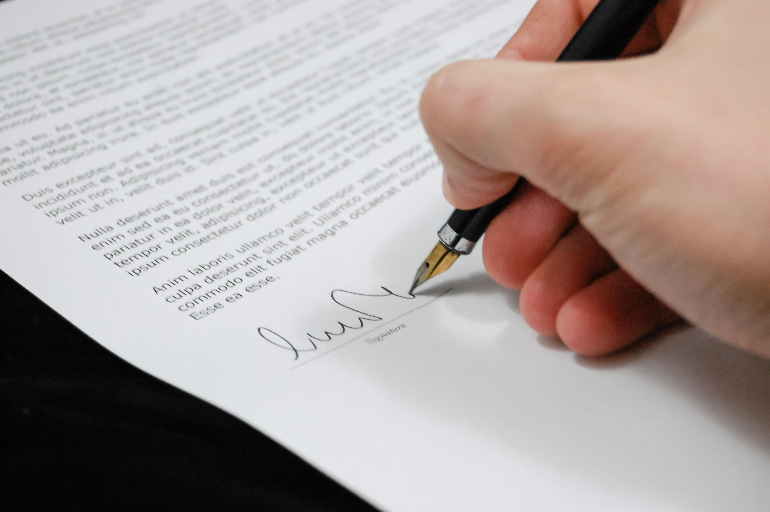 A person signing an insurance claim.
