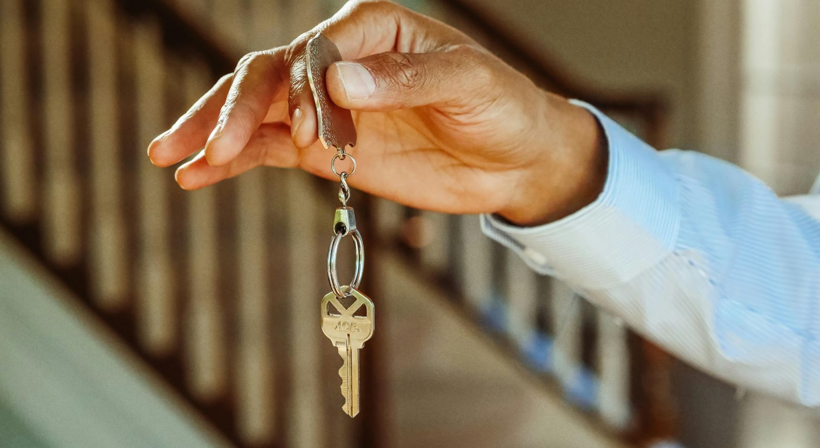 A landlord handling the keys of a property to a tenant.