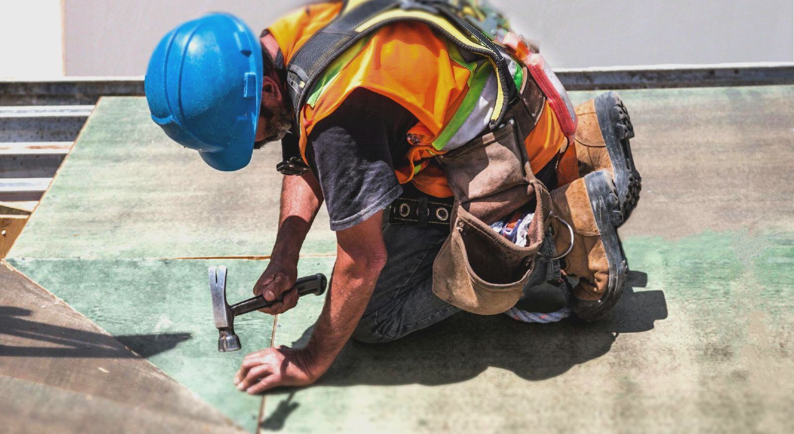 A technician repairing a floor.